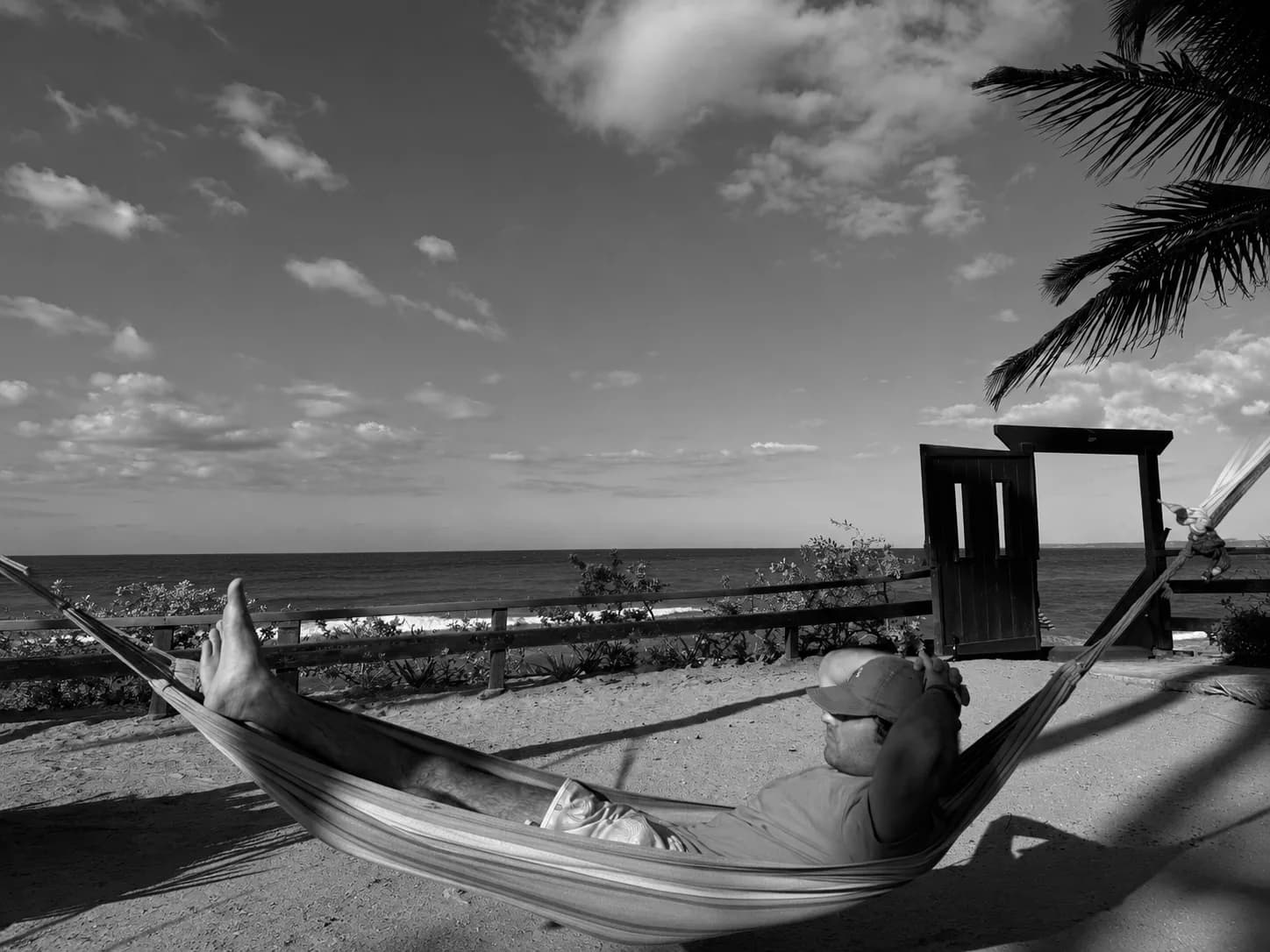 Ilan relaxing in a hammock by the ocean.